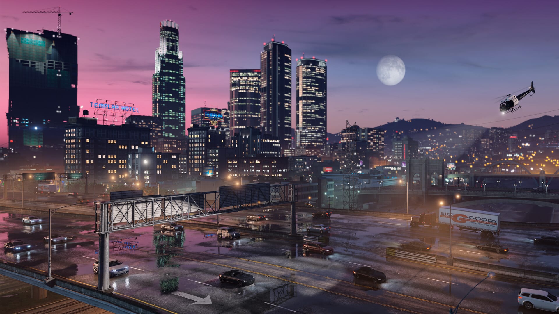 A shot of Los Santosat night in Grand Theft Auto, showing a large city with skyscrapers and bright lights. A helicopter is searching in the distance while traffic moves along the highway.