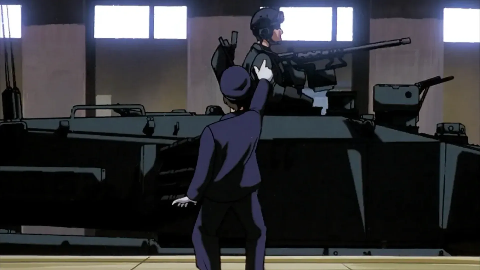 An image from the Patlabor anime, with a subway station attendant pointing at a tank driving through a subway station.