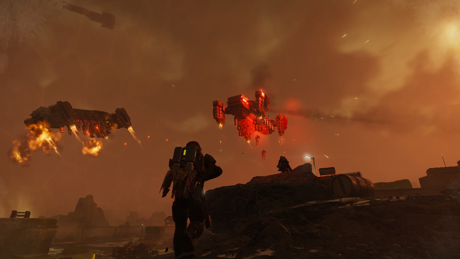 A lone Helldiver, equipped with a jump pack, jogs forward to engage with Automaton dropships that have just launched a new wave of robotic soldiers to fight.