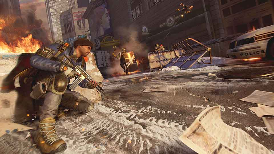 A Division agent takes cover in the snowy streets of post-apocalyptic New York while engaged in a firefight against crazed sanitation workers in a screenshot from The Division Resurgence