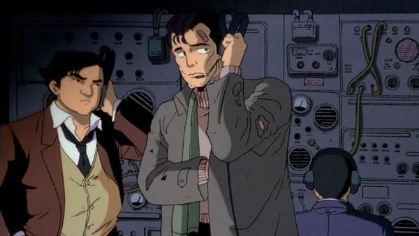 An image from the Patlabor anime depicting the character Goto in a disheveled state alongside Detective, both of whom are listening to headsets.