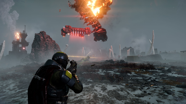 A helldiver advances on Automatons. One airship is preparing to drop reinforcements onto the tundra world, while another airship has been shot down with an explosion.